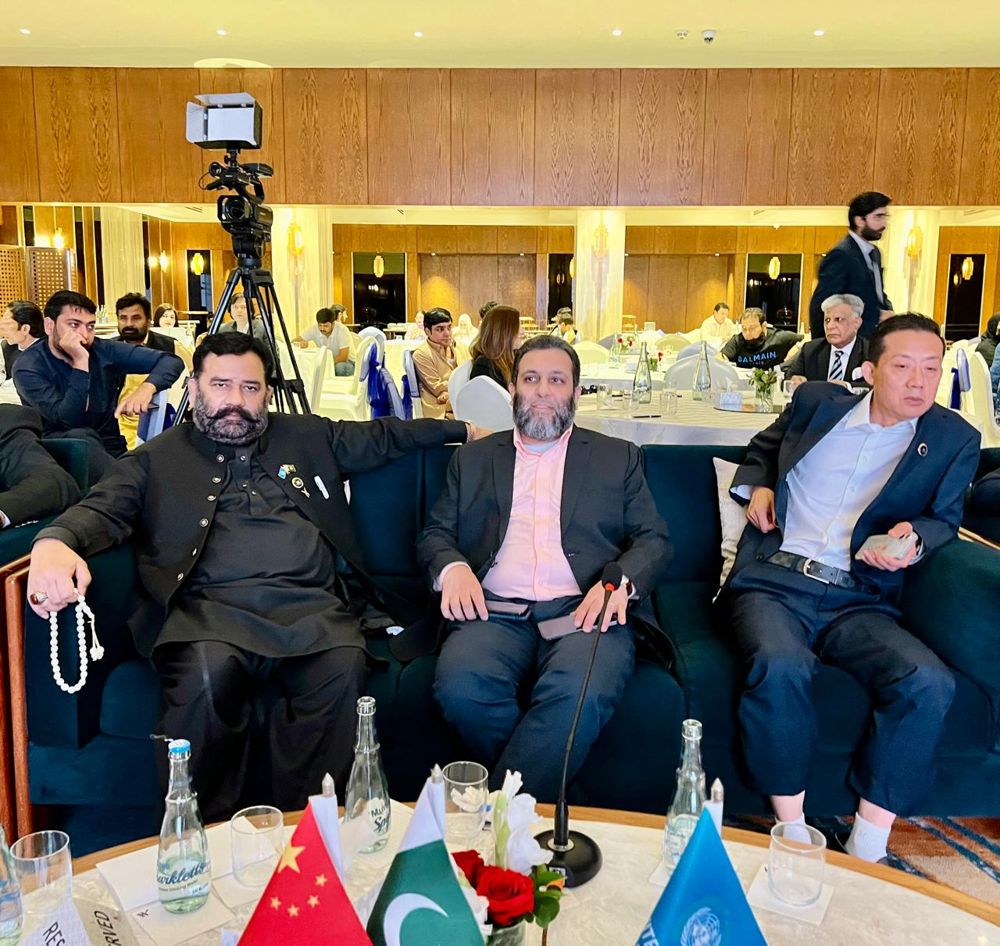 Delegates at the IOEC conference with China and Pakistan flags