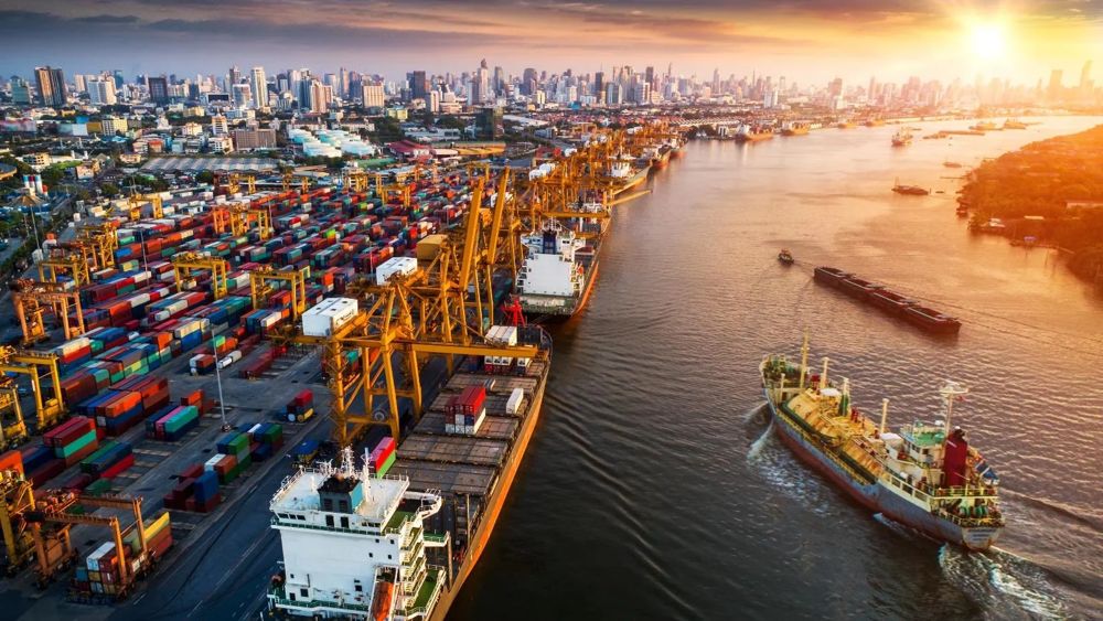 Container port and cargo ships at sunset